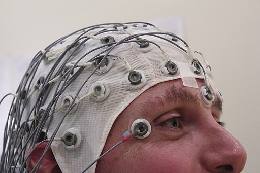 Photo of man wearing an EEG recording cap